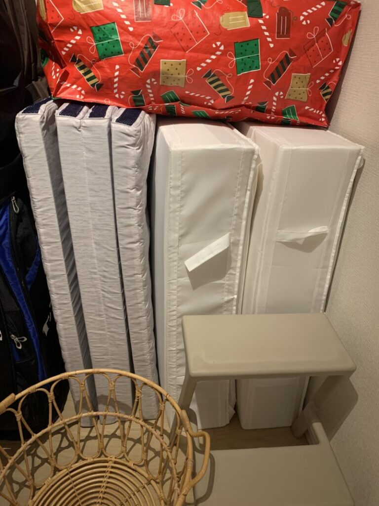 IKEAのスクッブという収納ケースに敷布団と低反発マットレスをそれぞれ一つずつ収納して立てかけています。マットレスも一緒に立てかけています。